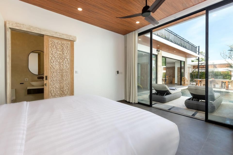 Master bedroom with pool view and king bed