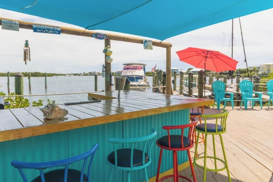 Relax at the Tiki bar for Happy Hour and watch your favorite sports game