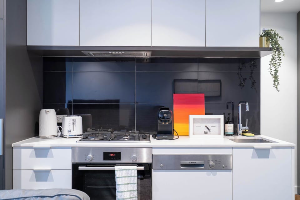 Full kitchen with capsule coffee machine, kitchen utensils, and dinning ware