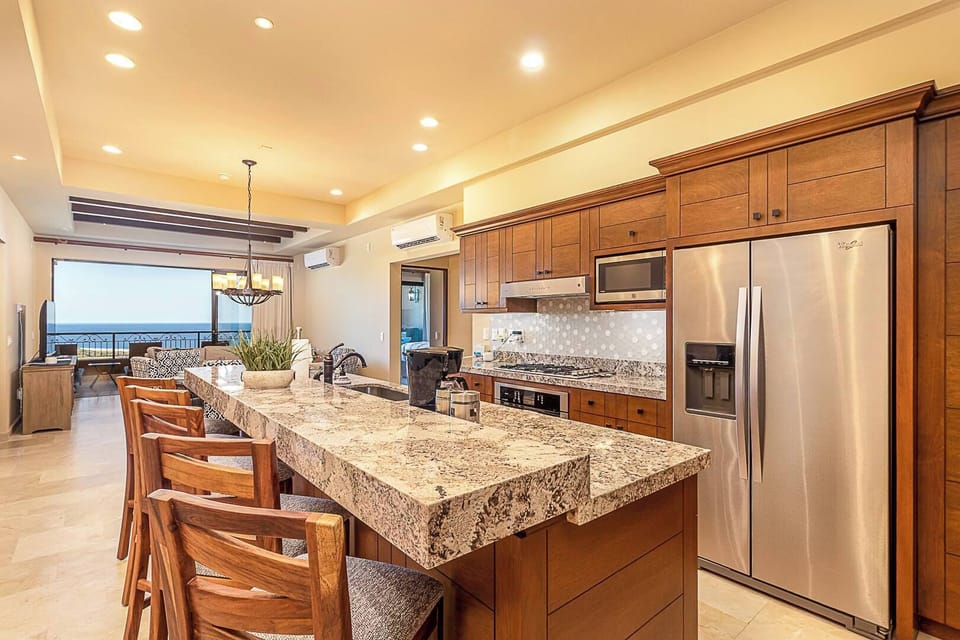 Open kitchen with modern appliances and island.
