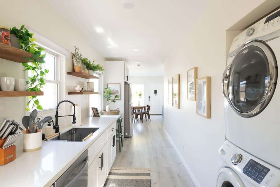 Wash, clean and dry in the galley-style kitchen with an attached laundry nook