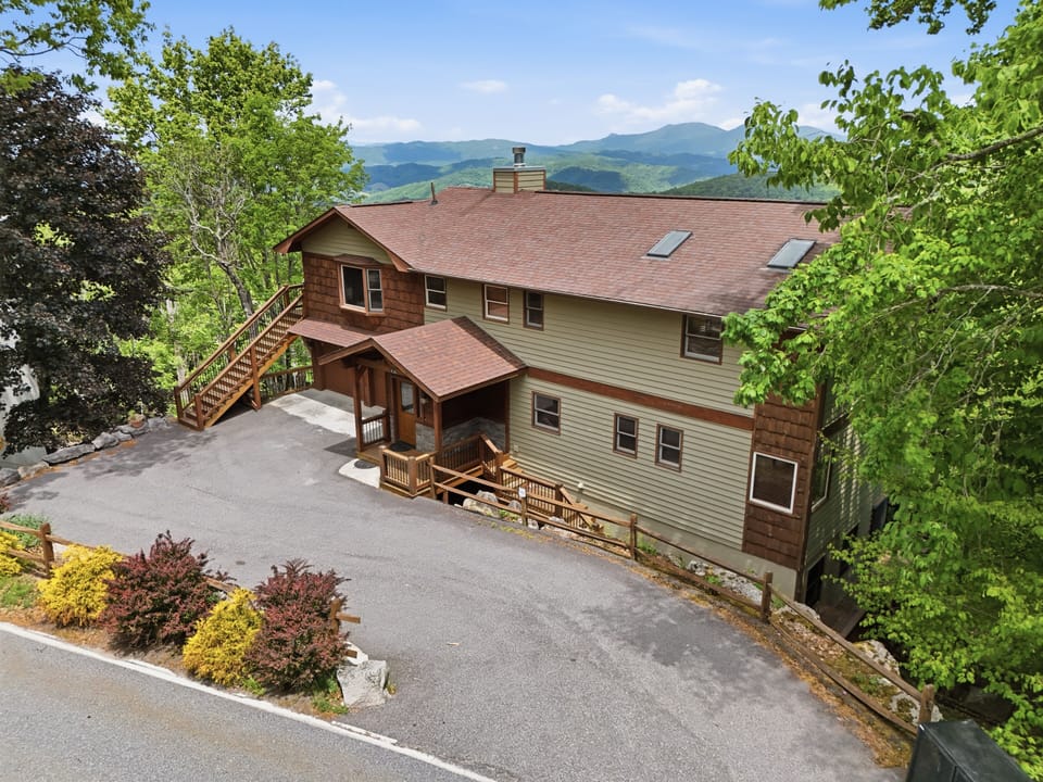 Lodge exterior nestled among colorful mountain landscaping and open sky.