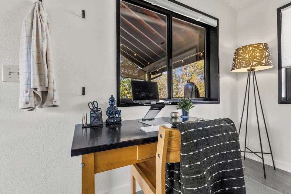 The desk in the living room, ideally going unused during vacation.