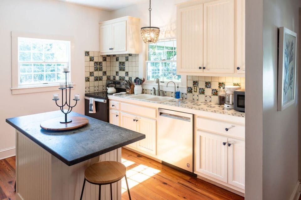Light-filled kitchen with breakfast bar, ample counter space, and warm coastal vibes