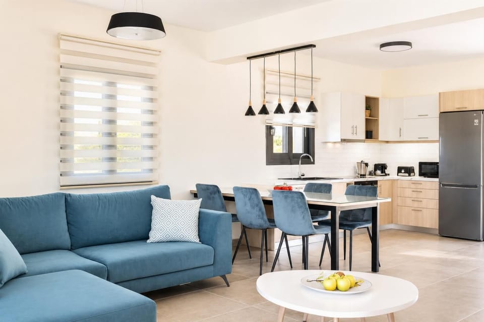 Living room with sofa, dining area, kitchen, A/C, WiFi internet, satellite TV, and sea views