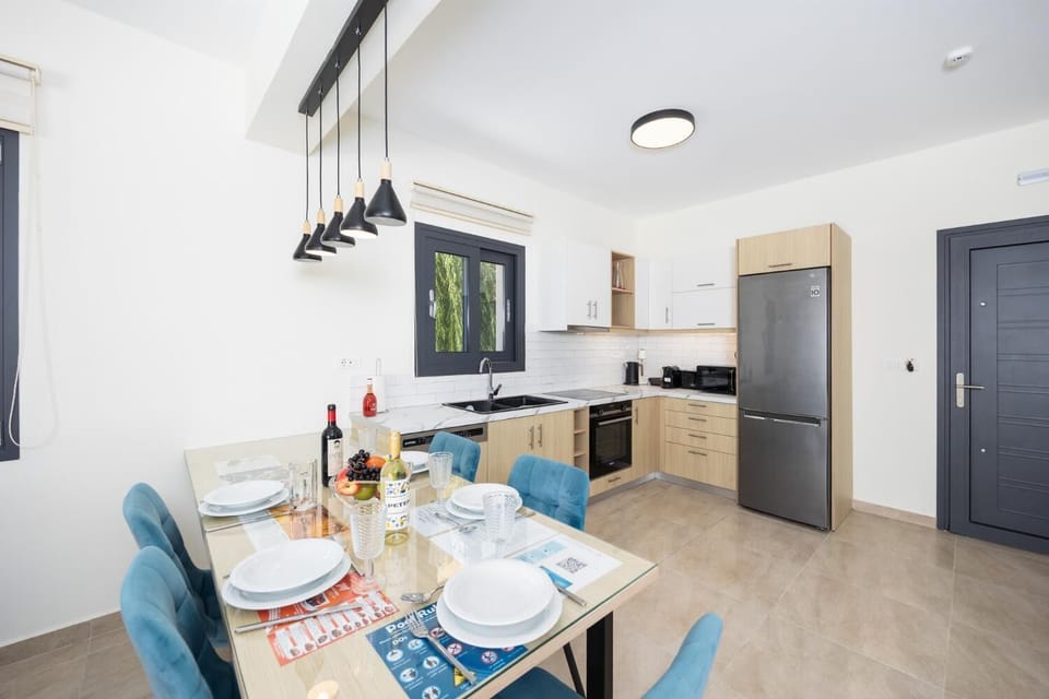Open-plan living room with sofa, dining area, kitchen, A/C, WiFi internet, and satellite TV