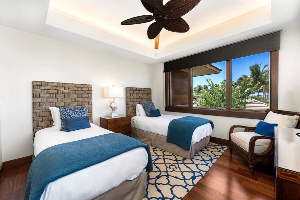 Twin guest suite with custom decor and mountain views from every bed.