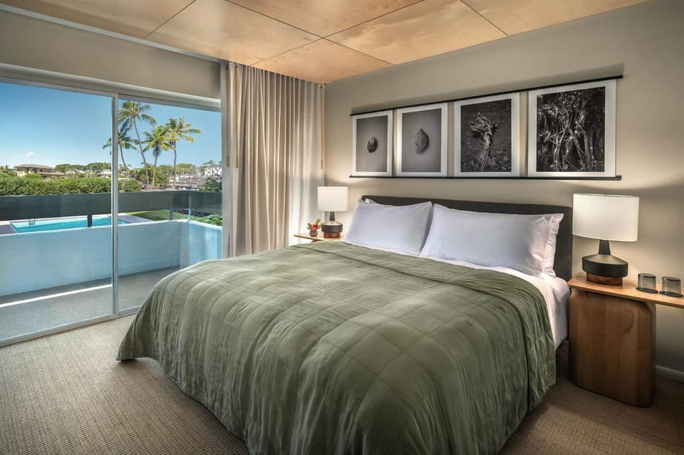 Unwind in a serene king bed with sunny balcony views.