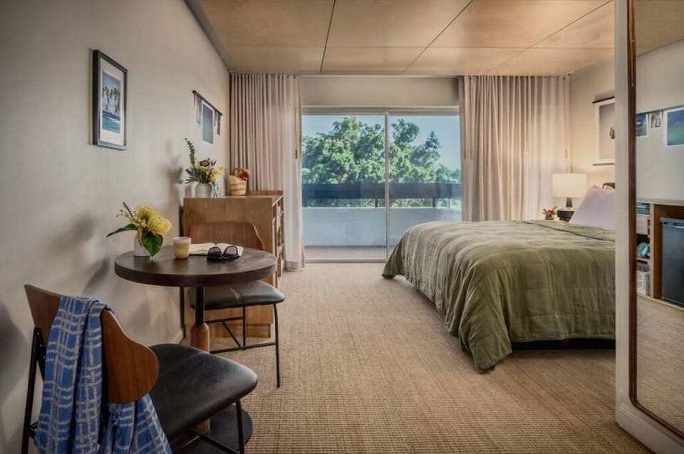 Wake up to sunlit views and a breezy private balcony.