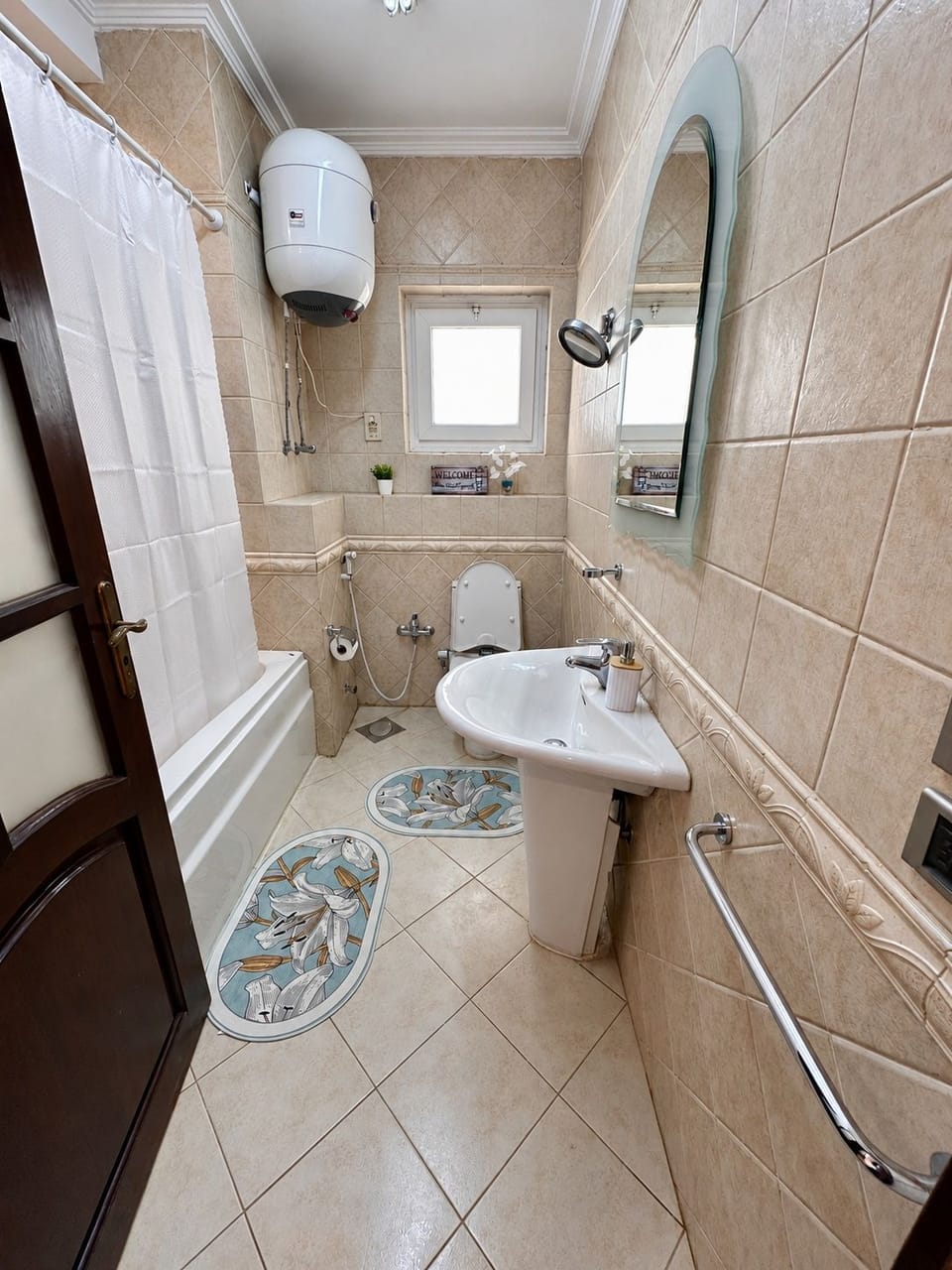 One of two full bathrooms, with a bathtub and overhead shower.