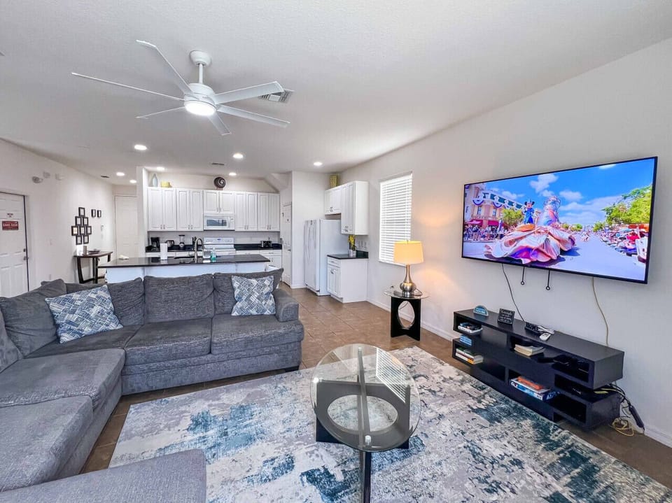 Cozy open-concept living room with smart TV and comfy sectional.