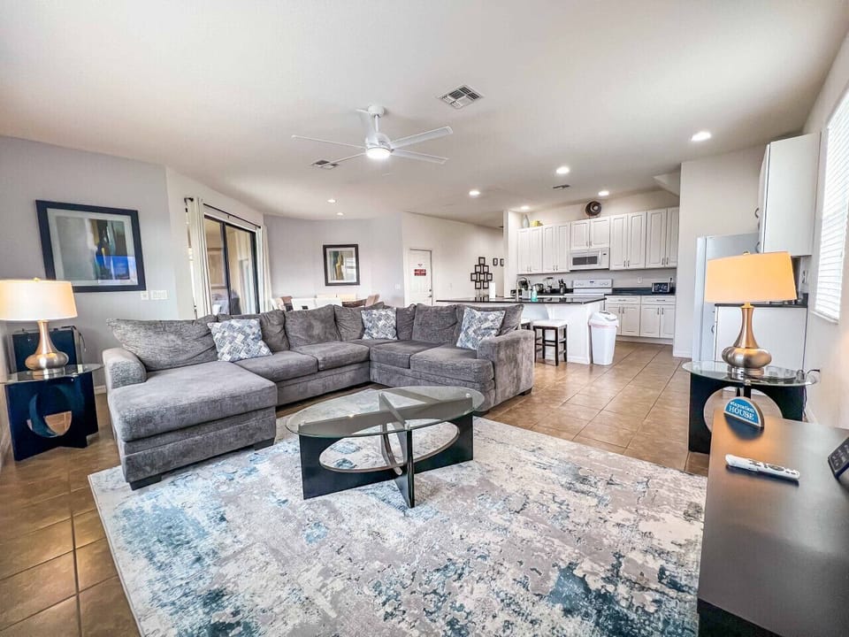 Bright open living space with plenty of seating and TV.