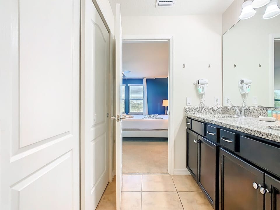 Elegant bathroom featuring double vanity and bright lighting.