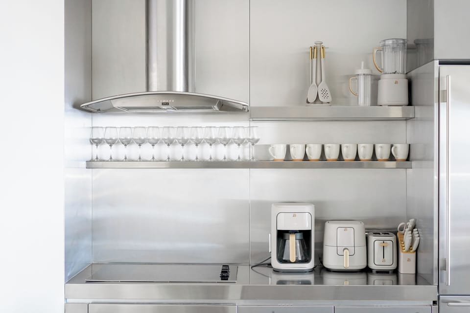 Includes a modern coffee maker, air fryer, toaster, and a full set of glassware