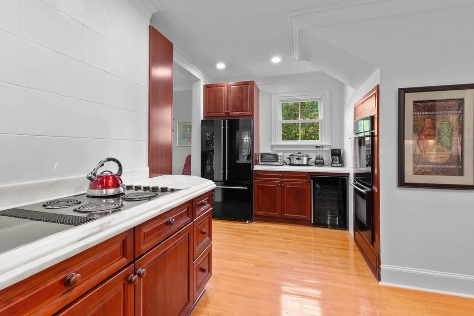 Fully stocked kitchen with two ovens and lots of natural light!