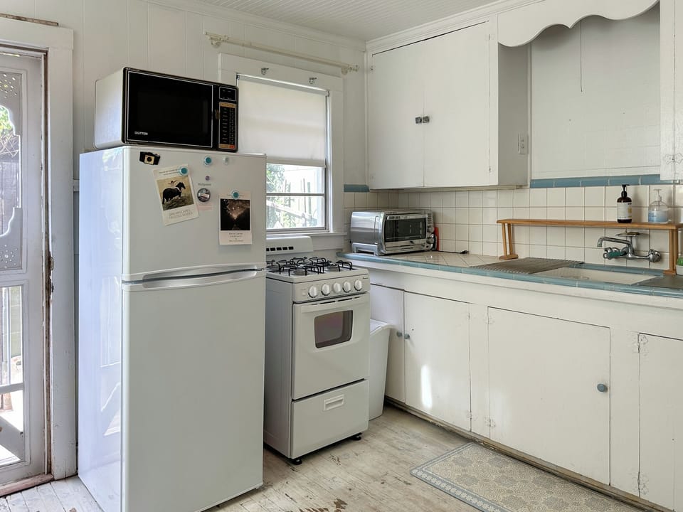 New fridge and stove/oven. Older microwave. Original sink. Handmade screen door.