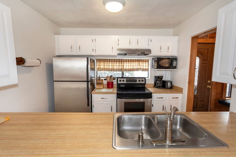 Bright kitchen and spacious countertops create a welcoming space for gathering and meal prep.