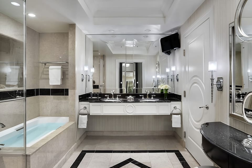 Refresh in a gleaming marble bath with double vanity.