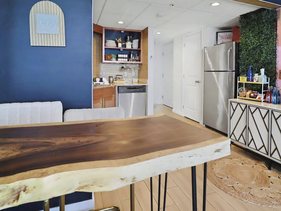 Dining space with a live-edge table and stainless appliances