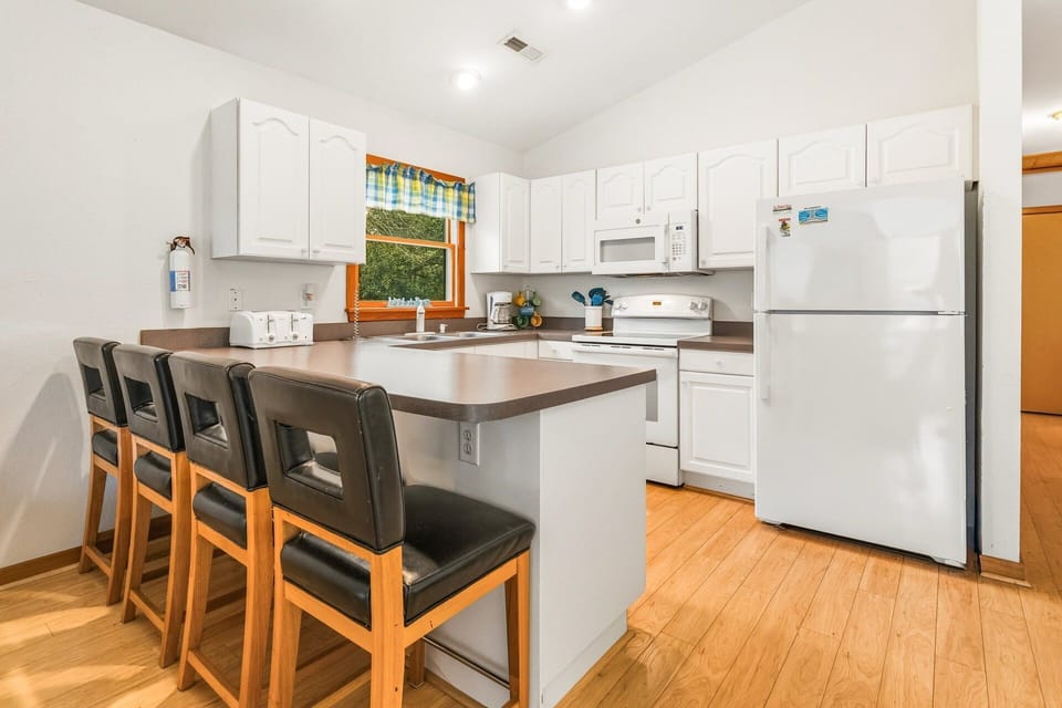 Prepare your favorite coastal meals in the well-equipped kitchen with bar seating for four.