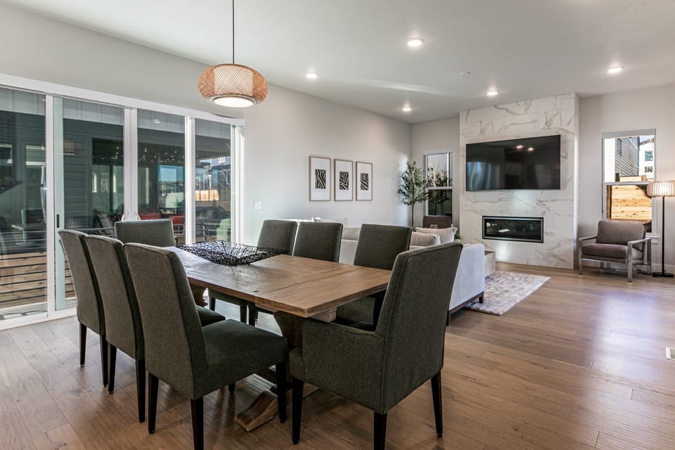 a large dining room with seating for 8 at the table and another 6 at the Island