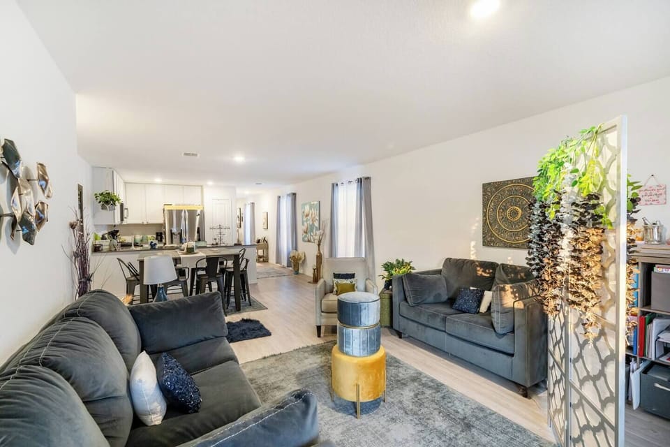 Bright living space featuring large windows and a mix of comfort and design.