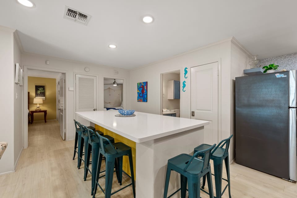 Spacious open layout with island seating and a relaxed coastal vibe.