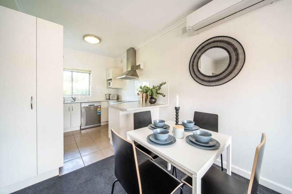 The dining space flows into a modern kitchen designed for connection and comfort.