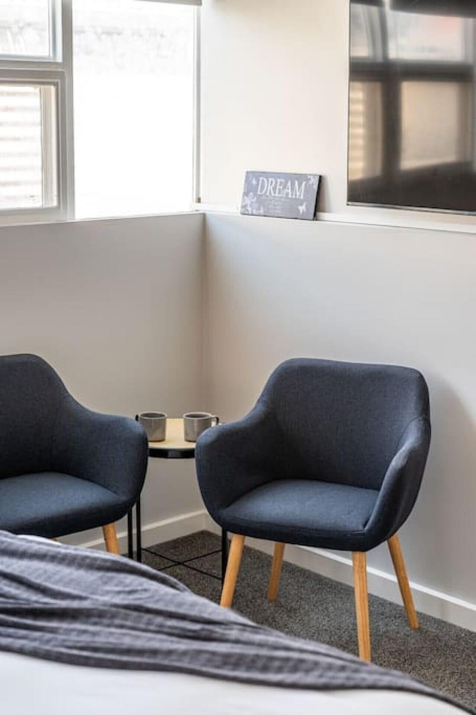 A cosy seating area in the bedroom caters to casual reading and conversation.