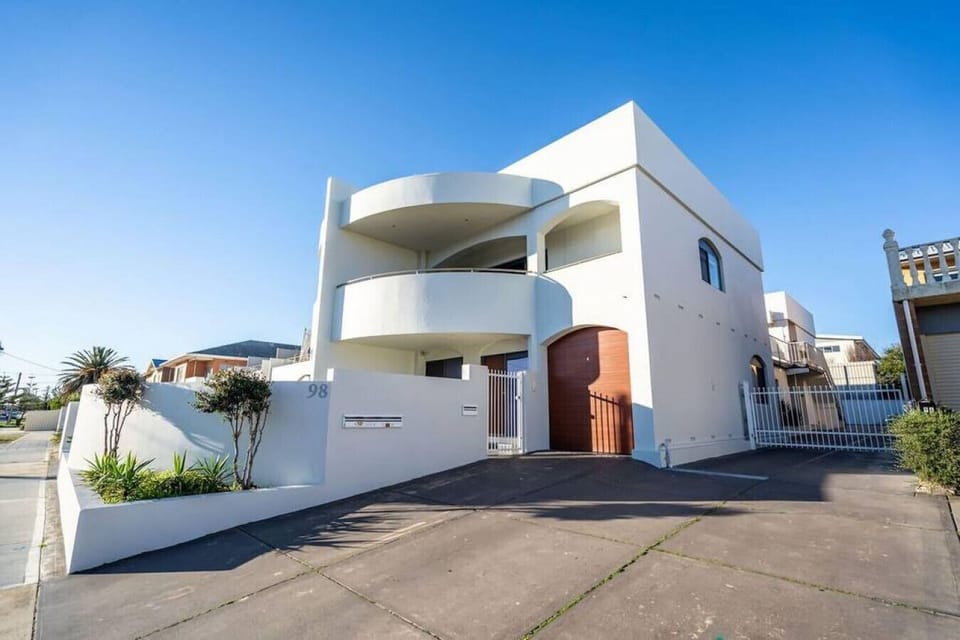 The contemporary exterior sets the tone on arrival, with clean lines and a private entry creating a welcoming first impression.