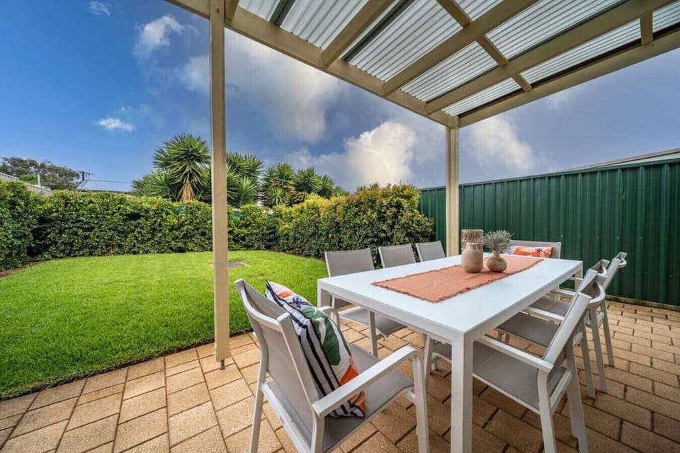 Enjoy long, easy meals under the covered patio, where alfresco dining overlooks the backyard.