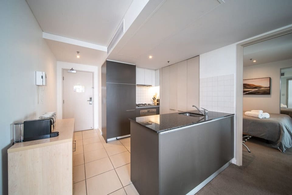 Cook with ease in the fully equipped kitchen featuring a gas cooktop, oven, dishwasher, fridge and sleek modern finishes ideal for both short stays and longer getaways.