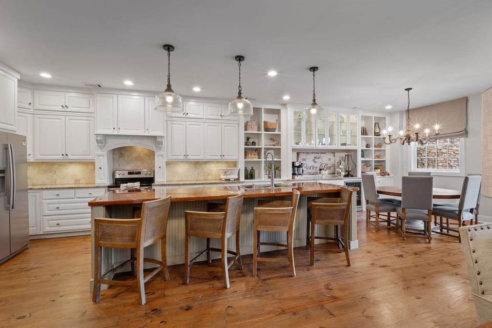 The large kitchen island with extra seating is perfect for casual dining, morning coffee, or gathering while meals are prepared.