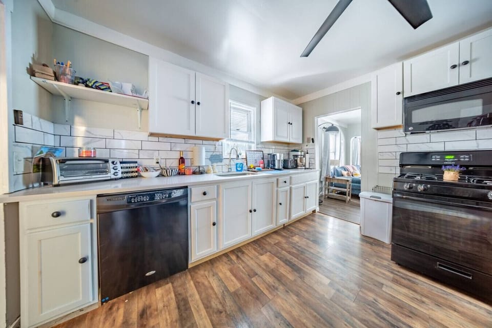 The kitchen is fully stocked, with stainless steel appliances and a gas stove