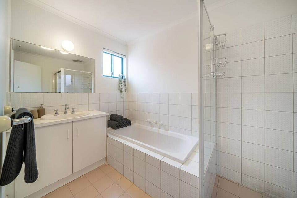 Refresh or unwind in the family bathroom, complete with a walk-in shower and a deep bathtub for evening soaks.