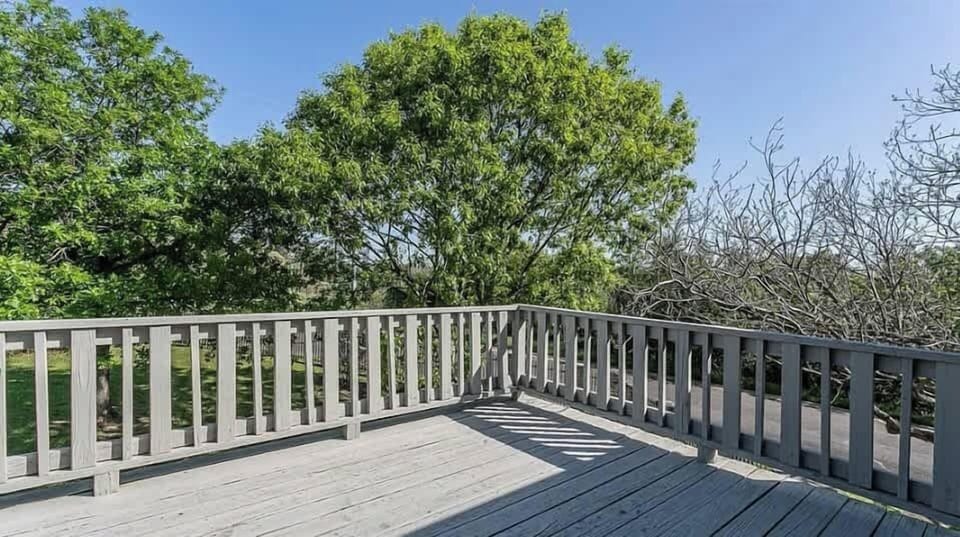 Balcony/Deck – An outdoor deck with wooden railings, perfect for morning coffee or evening relaxation, surrounded by lush greenery and serene views.