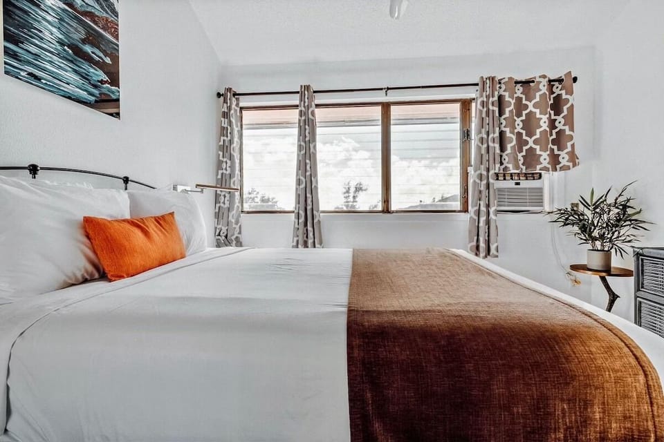 Stretch out on plush bedding beneath wide windows and sunshine.