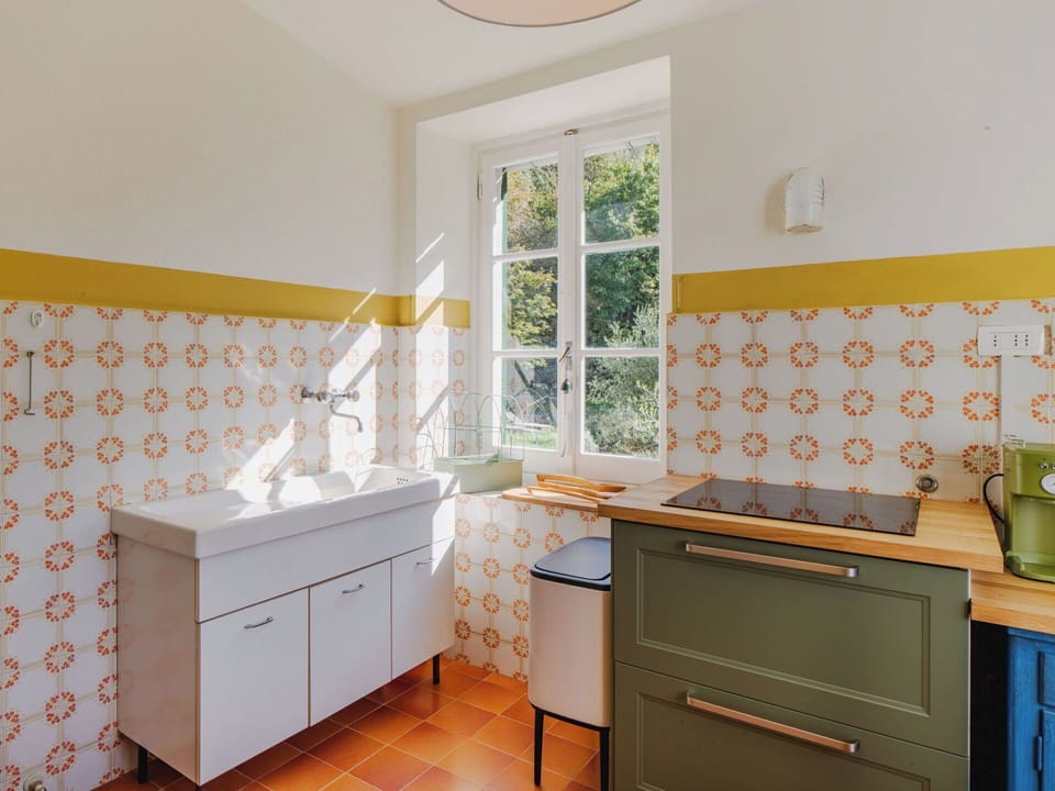 Yellow, Flooring, Interior Design, Floor, Cabinetry, Drawer, Kitchen, Tile, Countertop, Tap