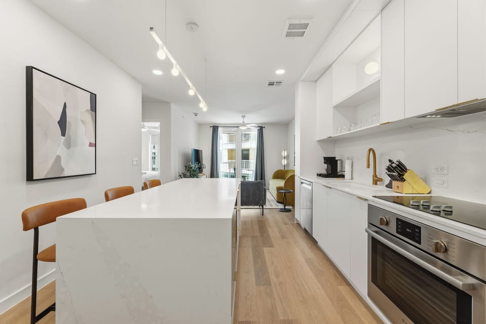 Bright and airy layout showing the seamless transition between the kitchen and living spaces.