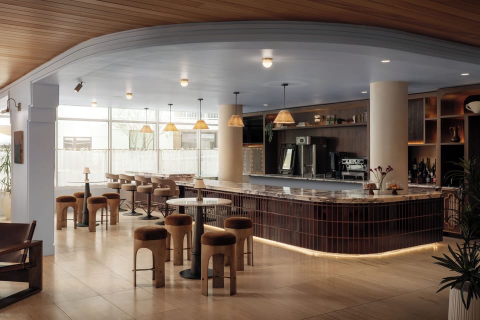 Stylish on-site lounge with cozy seating, artisan coffee, and a warm modern atmosphere perfect for slow mornings or evening cocktails.