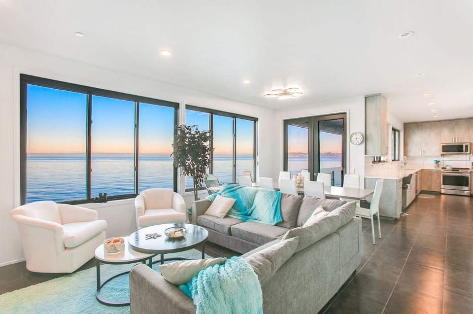 Relax in the living area where every glance meets the shimmering waters—your front-row seat to Bainbridge’s natural beauty.