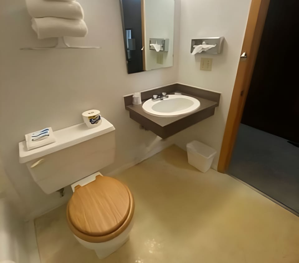Refresh easily with a clean vanity, mirror, and fresh towels