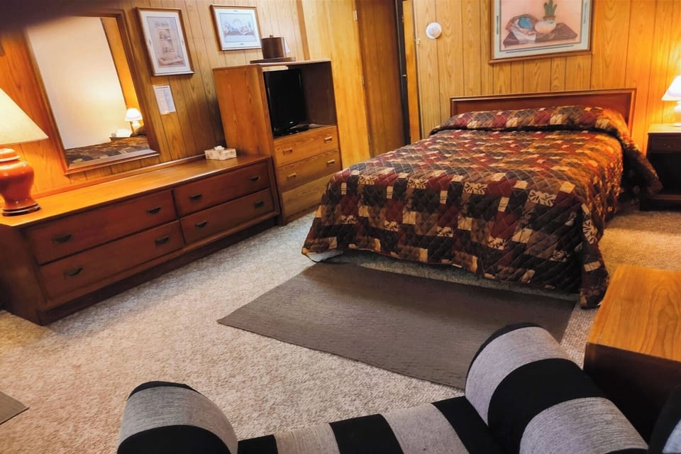 Relax into a comfortable queen bed in a warm retreat.