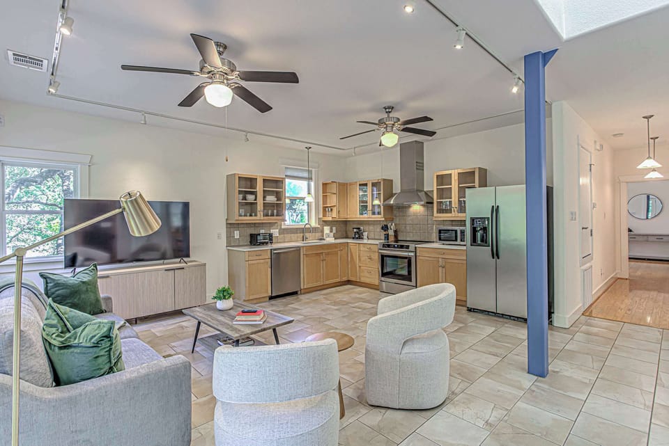 Sunlit, open concept living/kitchen space.