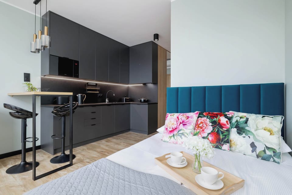 A tastefully designed open-plan studio filled with natural light and modern furnishings.