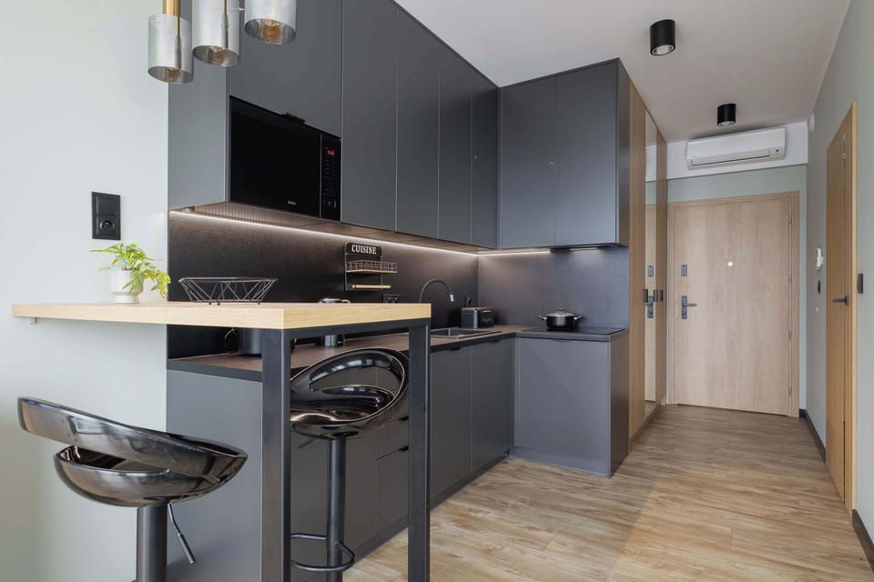 Smartly arranged bar-style dining space perfect for quick meals or morning coffee.