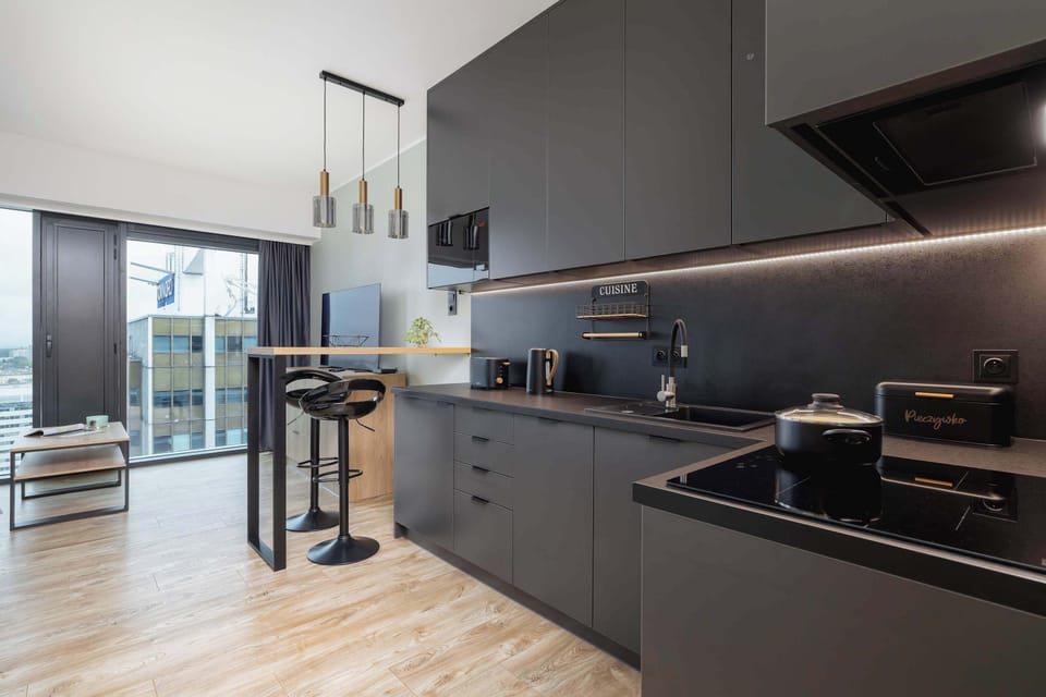 Sleek, contemporary kitchen space with dark cabinetry and high-quality appliances.