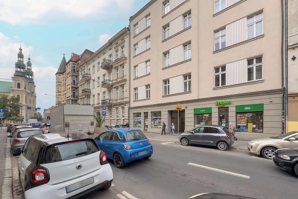 The street lined with classic townhouses shows a charming urban location perfect for walks and exploration.