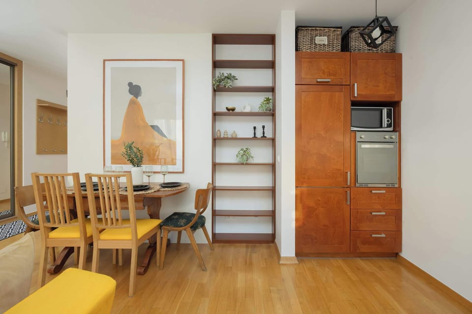 Open living area with a dining table and a large comfortable sofa.