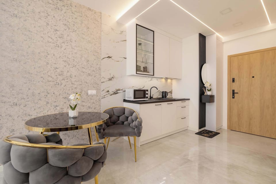 A sleek dining nook and textured walls create a refined yet cozy atmosphere.